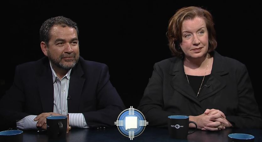 A man and woman sitting at a table.