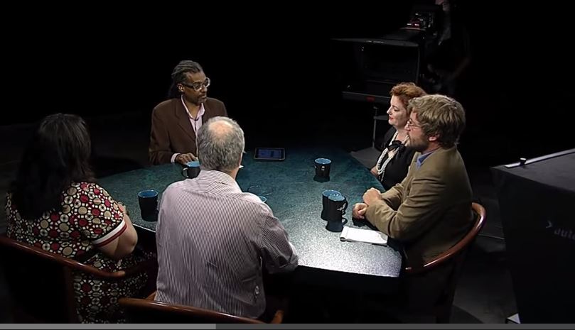 A group of people sitting around a table.