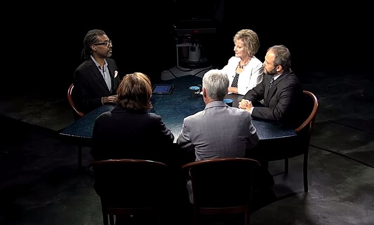 A group of people sitting around a table.