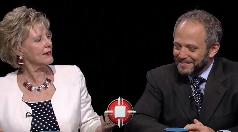 A man and a woman sitting next to each other.