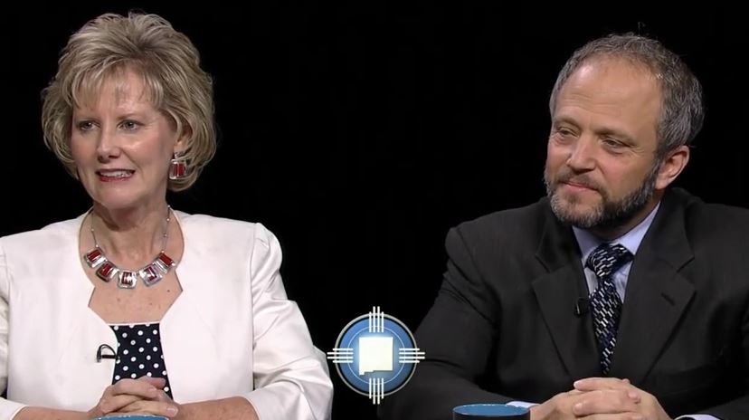 A man and a woman sitting next to each other.