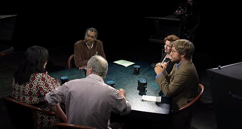 A group of people sitting around a table.