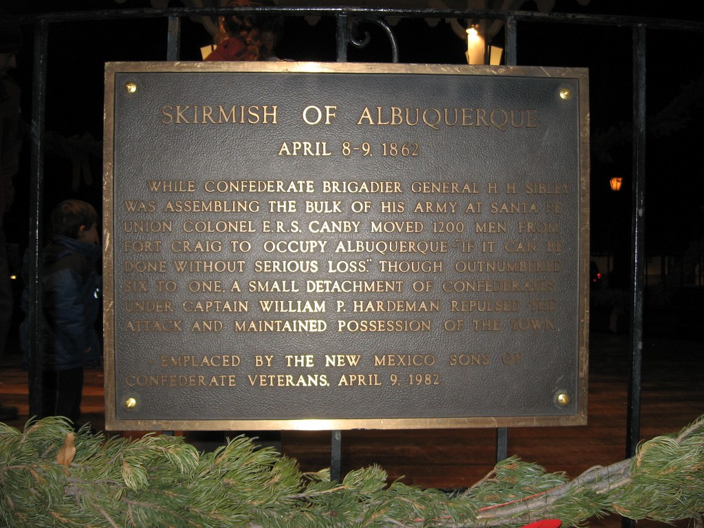 A plaque on a fence.