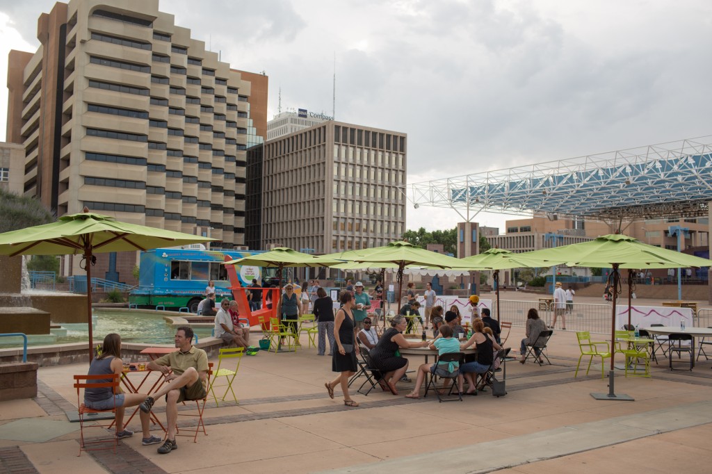 A group of people in a plaza.