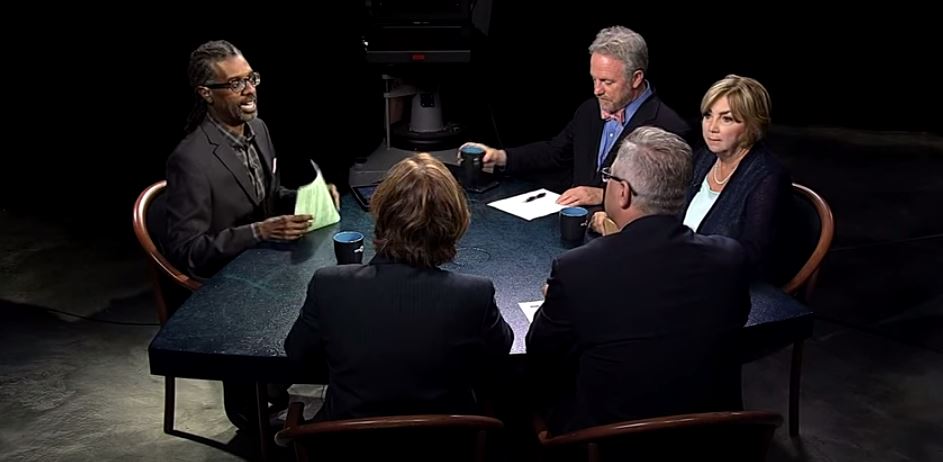 A group of people sitting around a table.