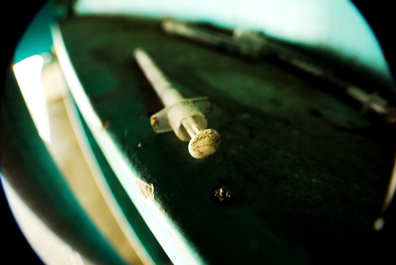 A syringe sitting on a table.