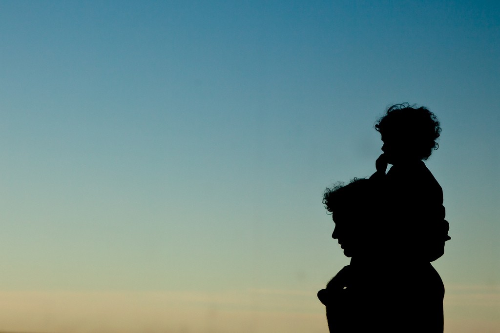 A silhouette of a man and a child.