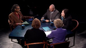 A group of people sitting around a table.