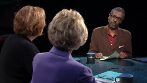 Three people sitting at a table.