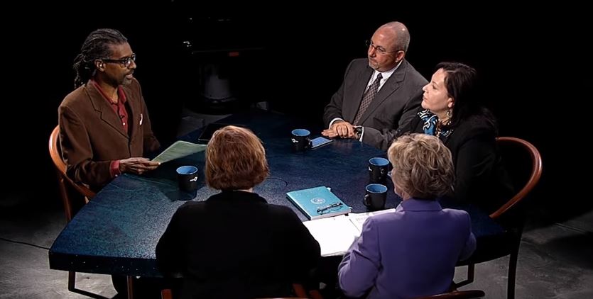 A group of people sitting around a table.