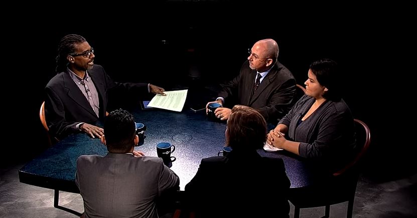 A group of people sitting around a table.