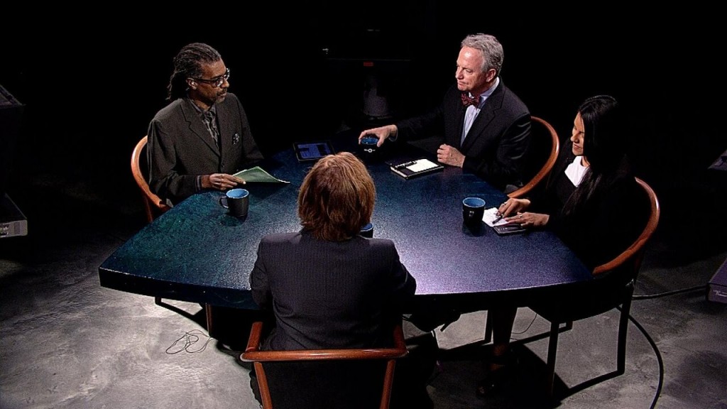 A group of people sitting around a table.