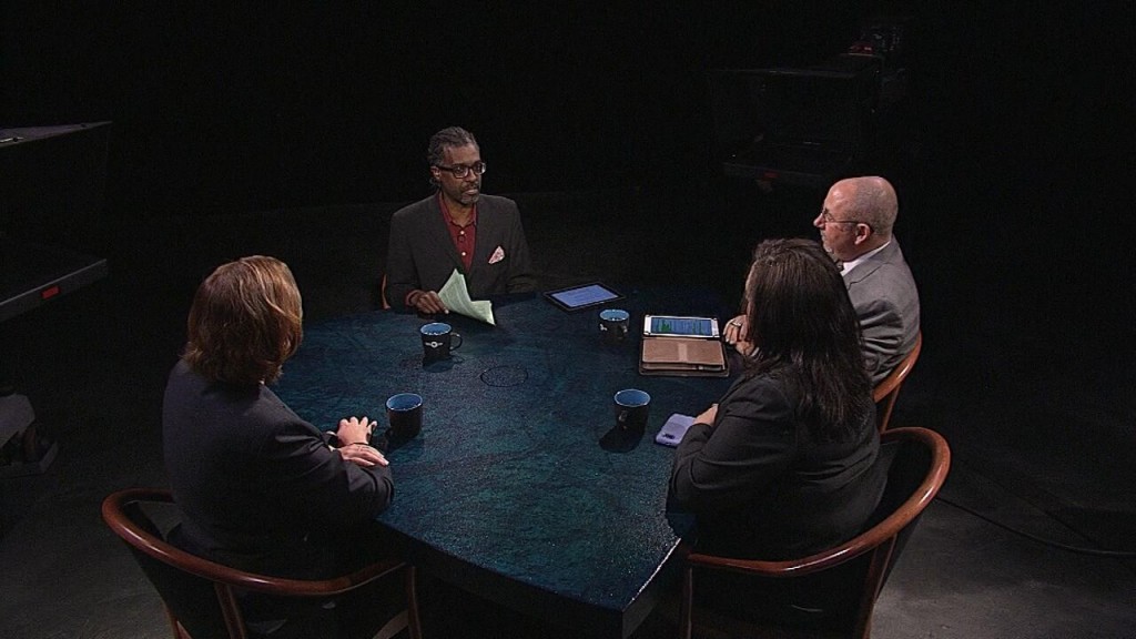 A group of people sitting around a table.