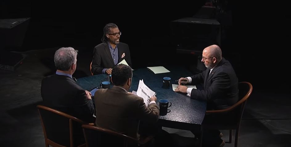 A group of people sitting around a table.