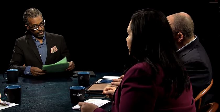 A group of people sitting around a table.