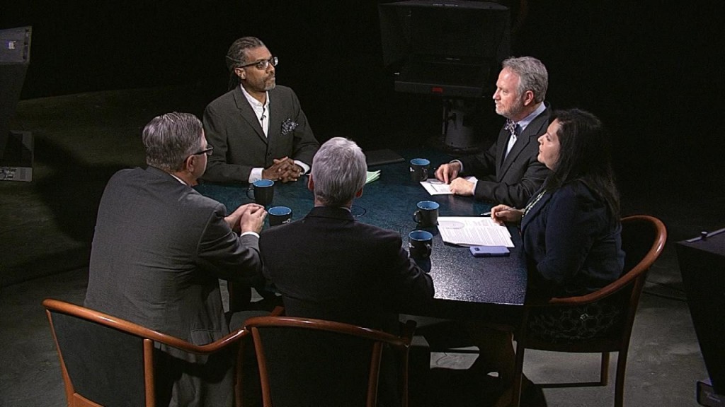 A group of people sitting around a table.