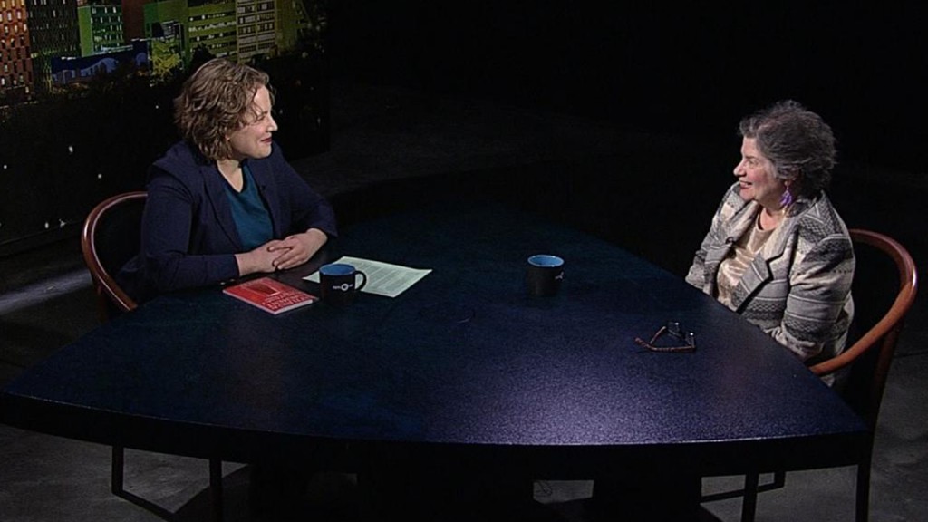Two women sitting at a table talking.
