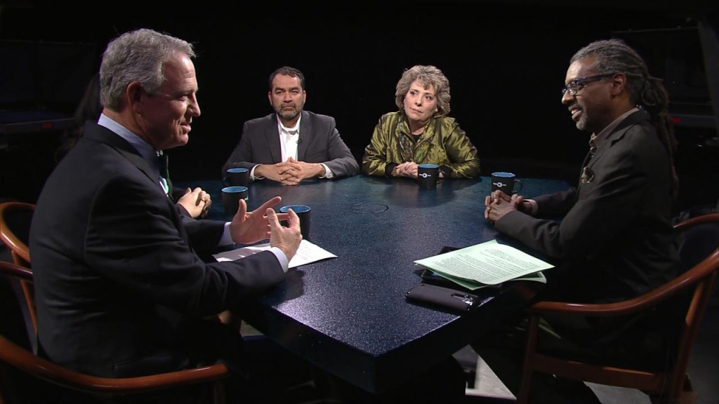 A group of people sitting around a table.
