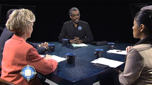 A group of people sitting around a table.