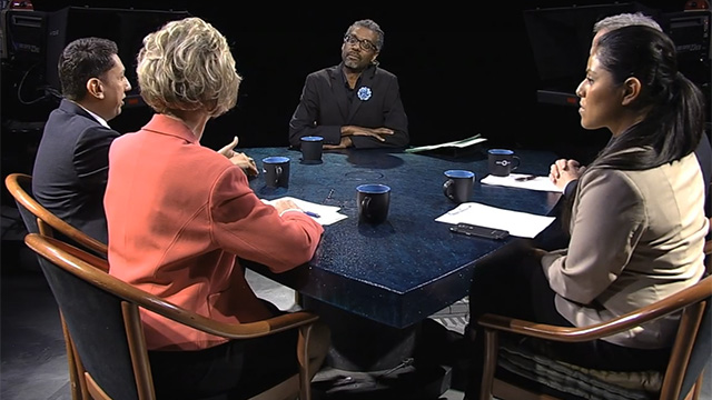 A group of people sitting around a table.