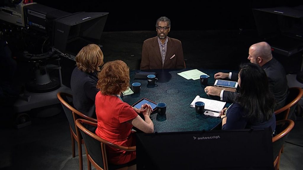 A group of people sitting around a table.