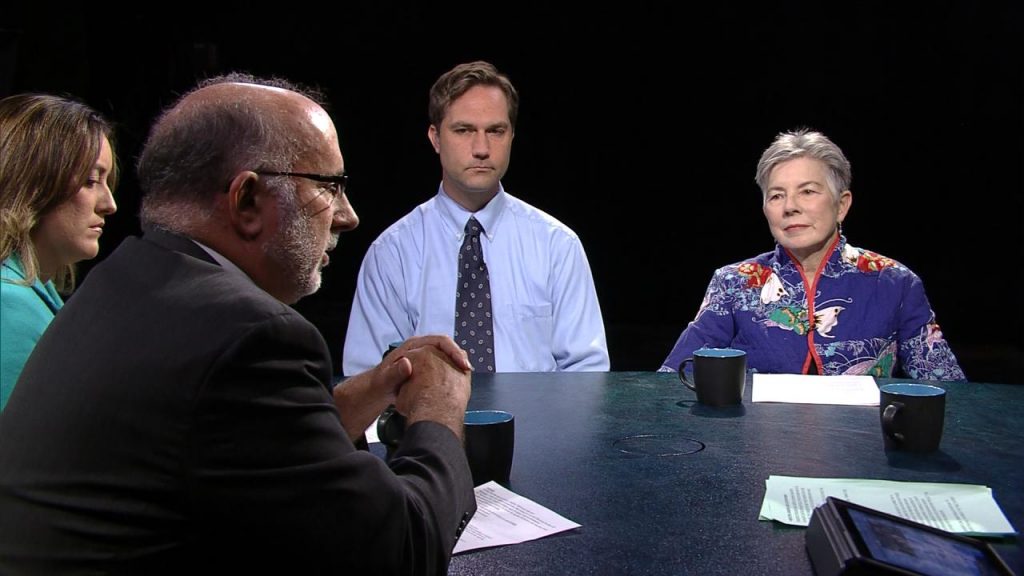 A group of people sitting around a table.