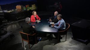 A group of people sitting around a round table.