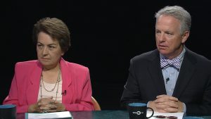 A man and woman sitting at a table.