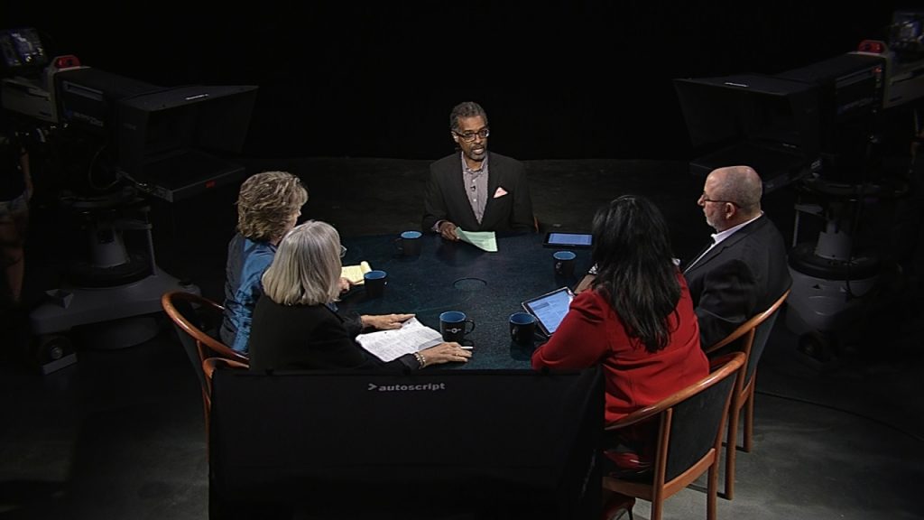 A group of people sitting around a table.