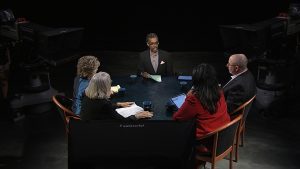 A group of people sitting around a table.