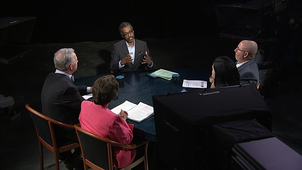 A group of people sitting around a table.