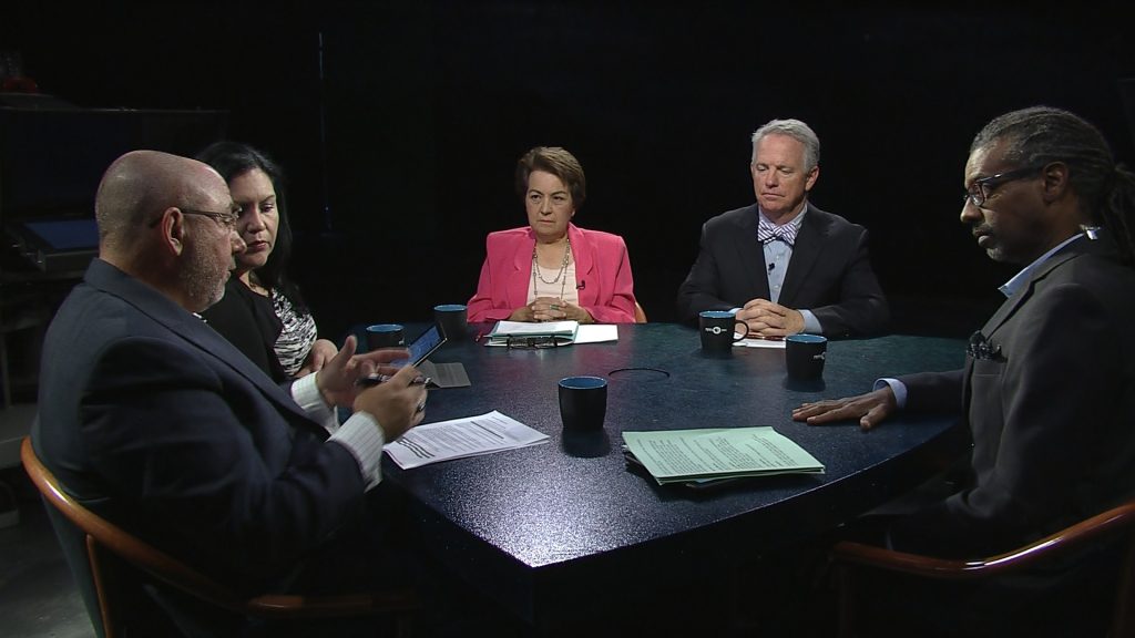 A group of people sitting around a table.