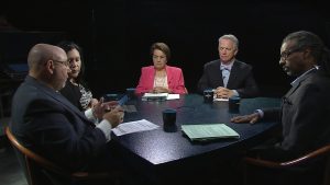 A group of people sitting around a table.