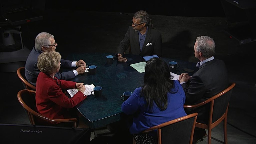 A group of people sitting around a table.