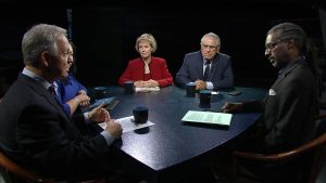 A group of people sitting around a table.