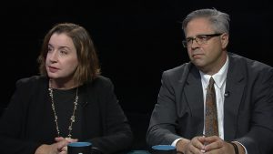 A man and woman sitting at a table.