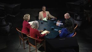 A group of people sitting around a table.