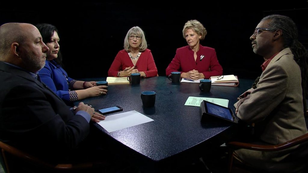 A group of people sitting around a table.