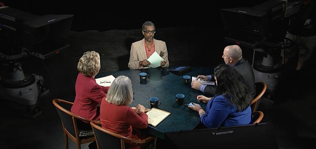 A group of people sitting around a table.