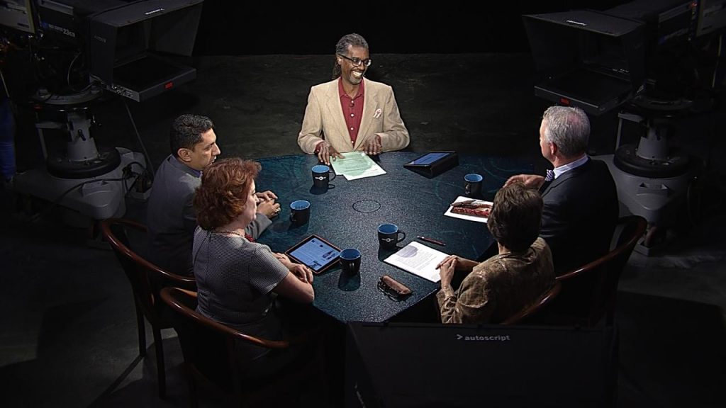 A group of people sitting around a table.