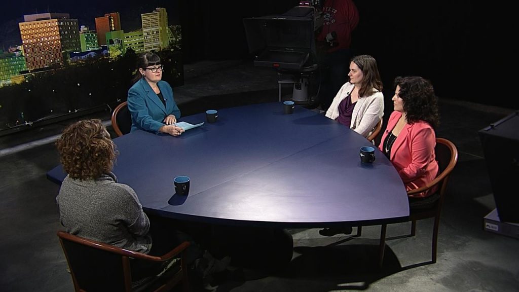 Four women sitting around a table in a television studio.