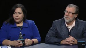 A man and woman sitting at a table.