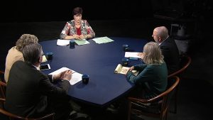 A group of people sitting around a table.