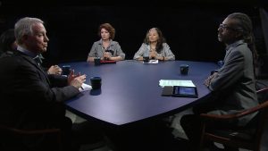 A group of people sitting around a table.