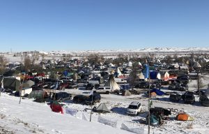 A large group of tents in a snowy field.