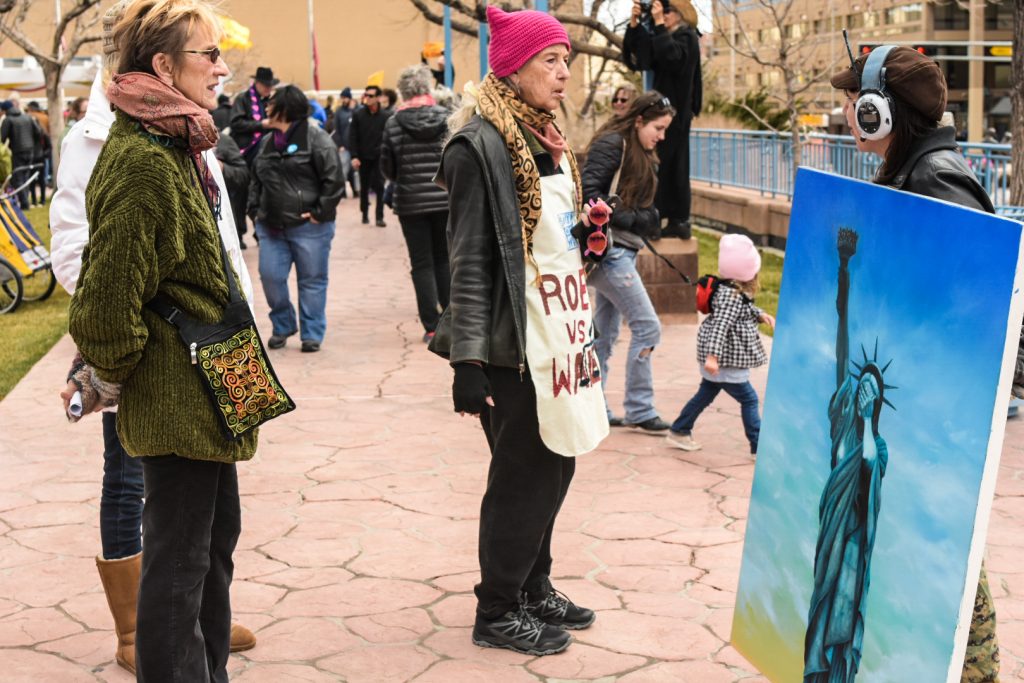 Katie Neeley, far right, exhibits her Oil Painting “My Lady,” on Civic Plaza, Saturday, Jan. 21st, 2017, in Albuquerque, NM. The rally in Albuquerque was a single gathering held in concert with hundreds of rallies and marches spread across the country and around the world. The sister rally in Civic Plaza was “to show solidarity across the nation and at home,” according to social media accounts affiliated with the rally. (Kevin Maestas) 