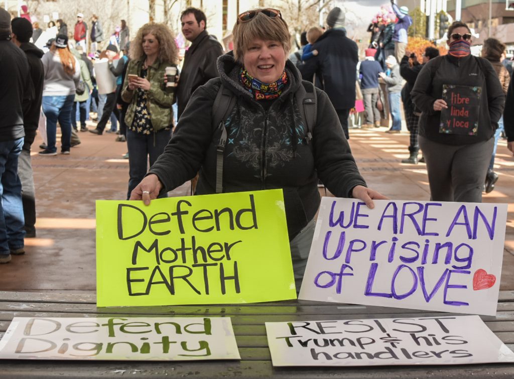 Belen resident, Kit Zimmerman, shares signs with rally goers during the Abq Women’s Rally, Saturday, Jan. 21st, 201, in Albuquerque, NM. The rally in Albuquerque was a single gathering held in concert with hundreds of rallies and marches spread across the country and around the world. The sister rally in Civic Plaza was “to show solidarity across the nation and at home,” according to social media accounts affiliated with the rally. (Kevin Maestas) 