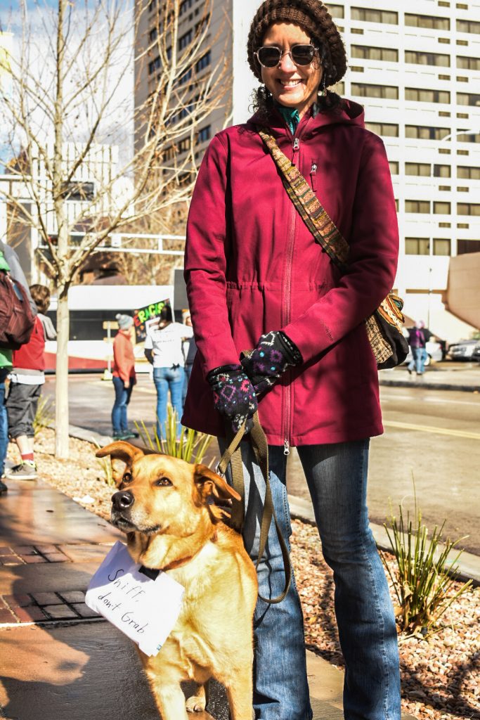 Luci Alfonso and Bumper stand east of the Civic Plaza main stage, during the ABQ Women’s Rally, Saturday, Jan. 21st, 2017, in Albuquerque, NM. The rally in Albuquerque was a single gathering held in concert with hundreds of rallies and marches spread across the country and around the world. The sister rally in Civic Plaza was “to show solidarity across the nation and at home,” according to social media accounts affiliated with the rally. (Kevin Maestas) 