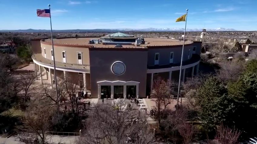 An aerial view of a large building with flags.