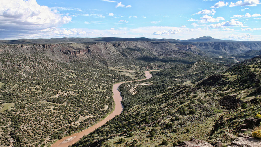 A view of a canyon with a river running through it.